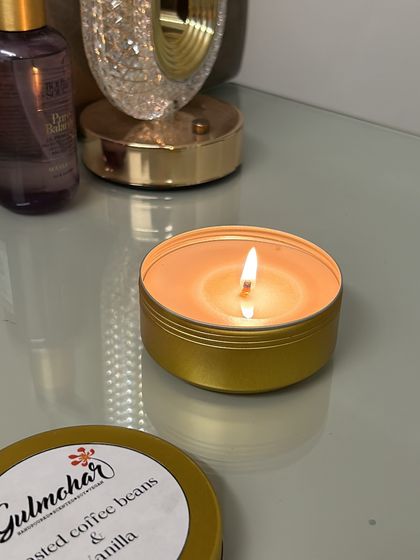 Tin candles are a hassle-free choice for return gifts. This one is lit, showing the beautiful glow it creates.