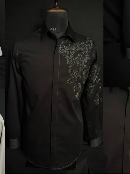 A black shirt from my collection, featuring abstract floral embroidery that flows from the shoulder down the sleeve. It's a perfect example of wearable art.