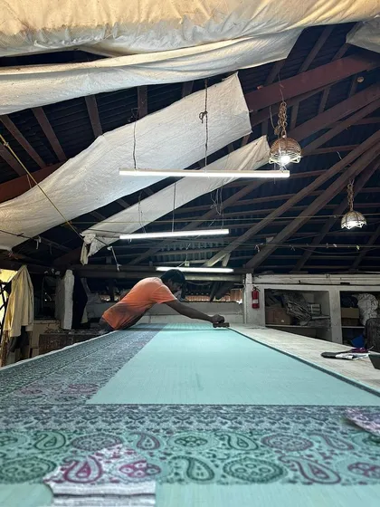 The quiet focus of our artisan as he prints a breezy kota saree. Using timeless floral and paisley blocks from our collection, he carefully places each motif, ensuring the final piece tells a story of a dreamy vintage summer.