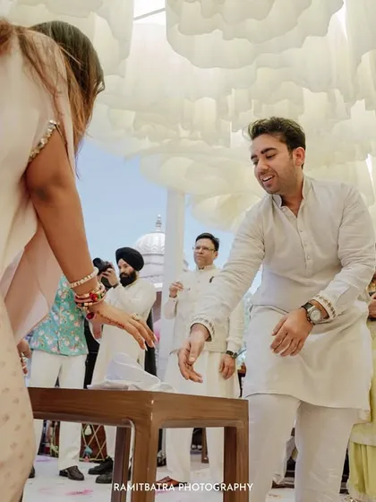 A candid moment from a wedding game, capturing the fun and laughter between guests during the celebration.