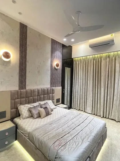 This angle focuses on the bed and the textured wall behind it. The combination of different materials and the warm lighting create a cozy and sophisticated retreat.
