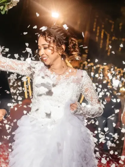 The grand reception entrance, with guests showering the happy couple in confetti. The energy and excitement of this moment is contagious.