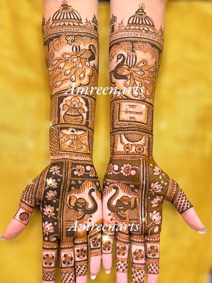 A full hand design combining elephants, peacocks, a kalash, and personalized text.