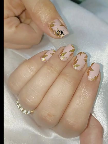 Another view of the nude and gold leaf nail art.