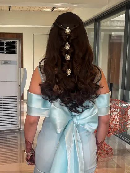 The back view of another beautiful engagement hairstyle. This is a variation of a bubble braid, created with the top section of hair and adorned with floral clips.
