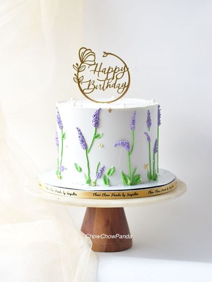 A closer look at the delicate buttercream lavender stalks on this elegant birthday cake.