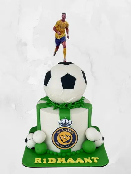For the ultimate football fan. This Al Nassr FC themed cake for Ridhaant features a 3D soccer ball and a topper of his favorite player. A guaranteed goal for any party.
