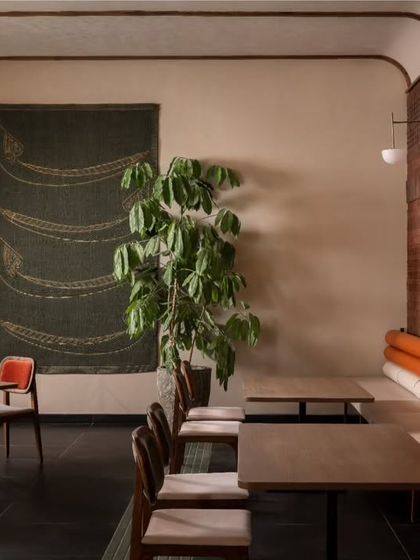 Another look at the dining area with the terracotta brick wall, showing the custom upholstered bench seating. We focused on providing comfortable and varied cafe seating options throughout the restaurant.