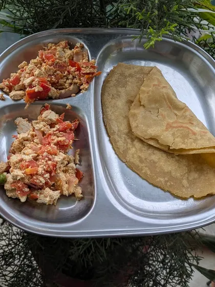 A simple lunch of tofu bhurji with a whole wheat paratha. This is a quick, protein-packed meal that is both satisfying and easy to prepare.