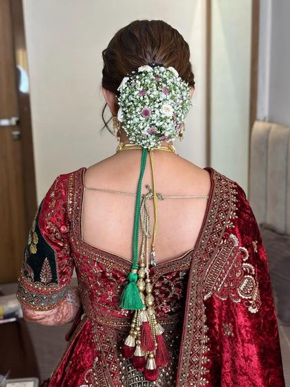 A close-up view of the floral hair bun, showing the intricate details of the flower arrangement.