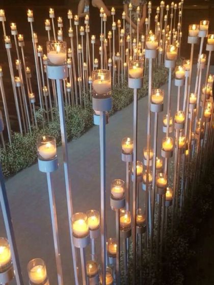 A romantic and enchanting walkway lined with hundreds of candles on tall stands. This creates an incredibly warm and intimate pathway for an evening event.