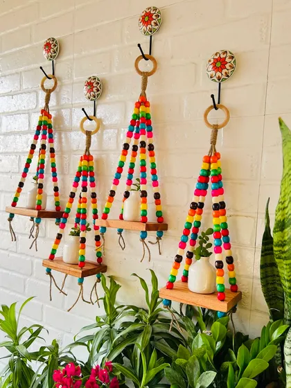Looking to create a 'Pinterest-worthy' wall? Our colorful beaded wall shelves are just the thing. Made with vibrant wooden beads, jute twine, and a natural wood shelf, they bring so much life and color to any space, especially balconies and garden areas.