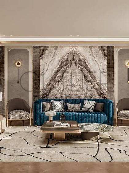 Serenity in every corner. This living space is a peaceful retreat, where soft textures, warm neutrals, and a bold blue sofa against a book-matched marble wall create a calming yet sophisticated oasis.