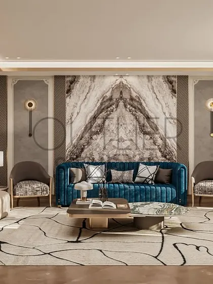 Serenity in every corner. This living space is a peaceful retreat, where soft textures, warm neutrals, and a bold blue sofa against a book-matched marble wall create a calming yet sophisticated oasis.