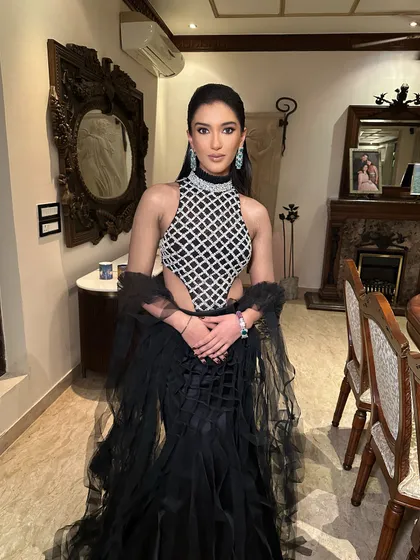 The full view of this unique black ensemble with a diamond-patterned top. A perfect look for a fashion-forward client.