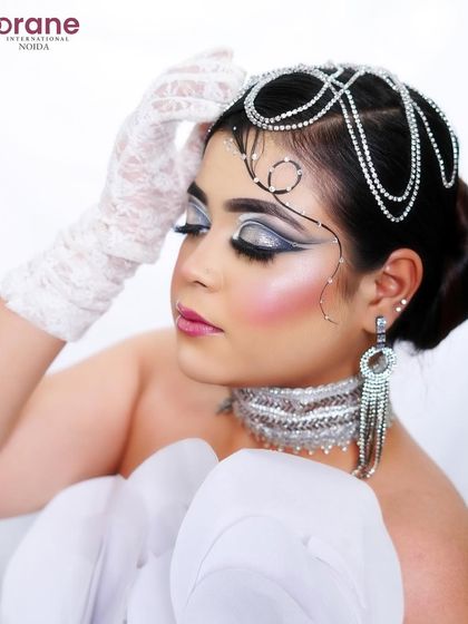 This side profile shows the elegant sweep of the graphic liner and the sparkle of the accessories.
