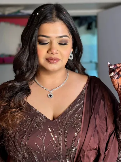 A close-up of this client's glam look. The smokey brown eyes and diamond jewelry create a look of pure sophistication.