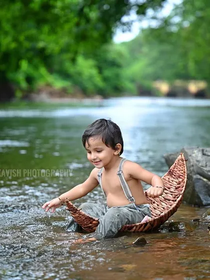 A candid moment of the baby exploring the water during his outdoor nature shoot.
