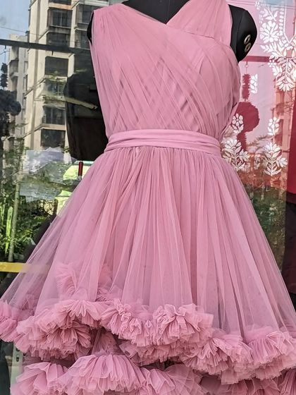 This cute pink frock with a ruffled, layered skirt is a lovely choice for a party. It's not too long, making it easy for little ones to run around and play.
