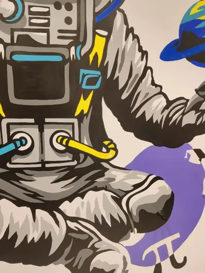 Close-up on the torso and hands of the astronaut mural. The bold lines and pops of colour against the grey suit were chosen to make the artwork stand out on the large wall.