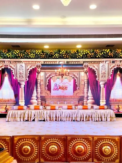 For a Ram-themed thread ceremony, we designed this grand stage setup at Siddharth Banquets. The backdrop features palatial arches and rich drapery, complemented by a stage fascia with traditional motifs and marigold floral arrangements to create a truly royal ambiance.