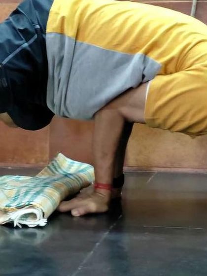 An arm balance, Bakasana (Crow Pose).