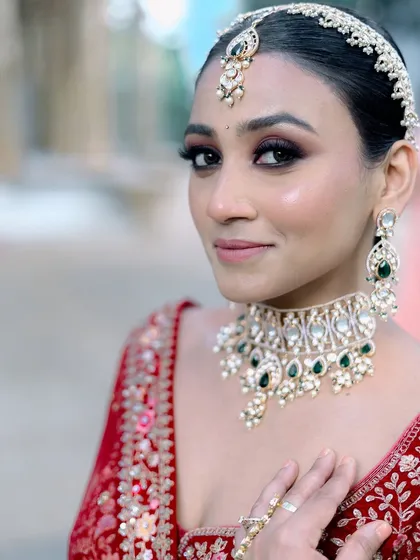 A classic red lehenga calls for makeup that is both traditional and breathtaking. I focused on creating a sharp, smokey eye to define her features, balanced with a radiant complexion that ensures the bride looks flawless from every angle.