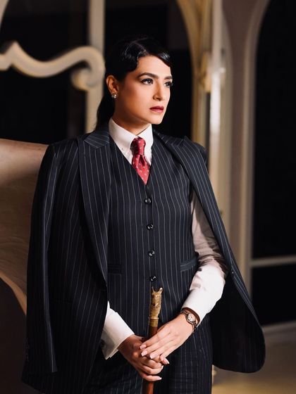 A full-length shot capturing the entire powerful ensemble, with the makeup tying together the vintage-inspired, authoritative vibe.