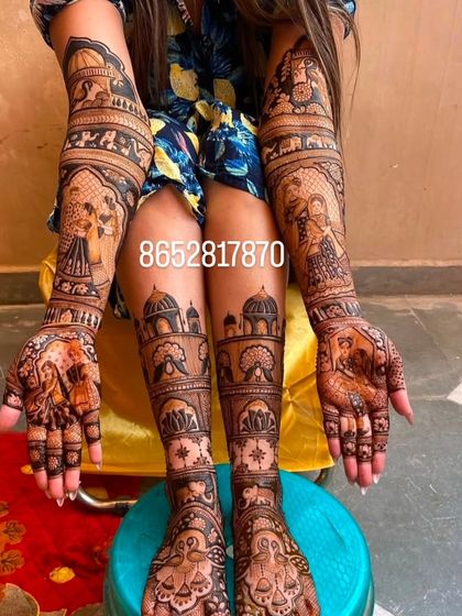 This photo shows a complete bridal set with matching architectural and figurative designs on both the arms and legs.