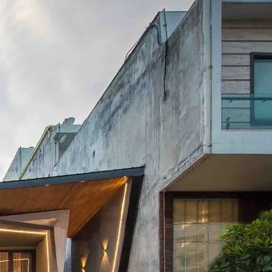 A detail showing the junction between the new architectural form and the neighboring building, highlighting the project's contextual sensitivity.