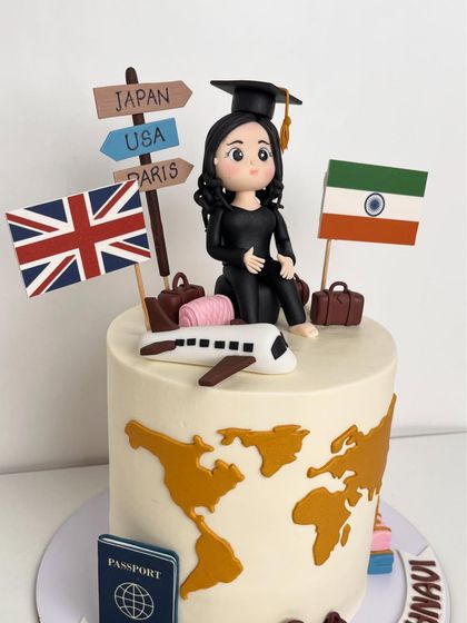 A close-up of the handcrafted graduation figurine and the travel-themed toppers.