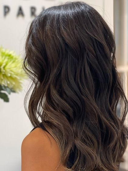 The beautiful waves of a Brunette Balayage, showcasing how the subtle highlights catch the light to create movement and texture.
