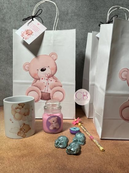 Our teddy bear-themed return gift bags are perfect for a little one's birthday. Each bag holds a customised mug, a small candle, a pencil with an eraser, and some of our handmade chocolates.