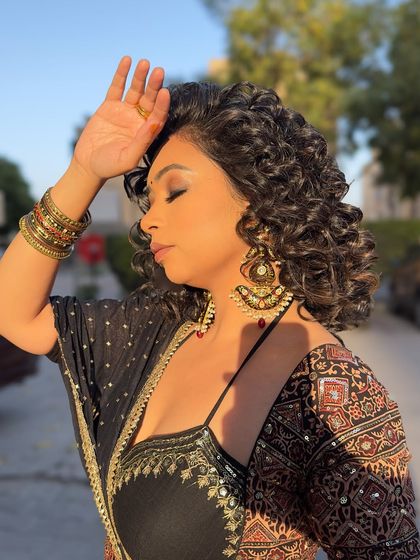 Golden hour in my festive lehenga. The warm sunlight brings out the rich colors and intricate details of the Ajrakh print and the heavy earrings.