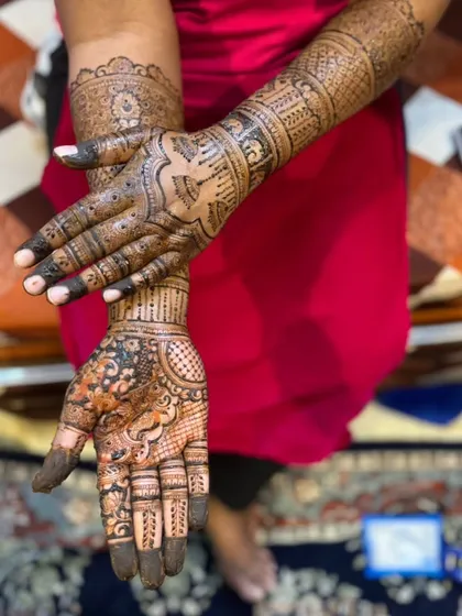 A creative pose showing both the front and back of the hands. This highlights the continuity of the design and the different patterns used on each side.