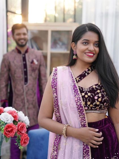 A beautiful candid-style shot focusing on the bride-to-be. The intricate details of the velvet lehenga top are clearly visible here.