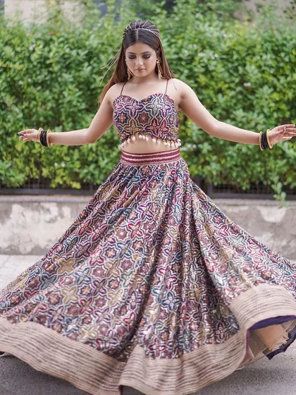 This printed, multi-color lehenga with a spaghetti-strap top is a fun and modern choice for a Mehendi or Haldi shoot. The twirling shots show its beautiful movement.