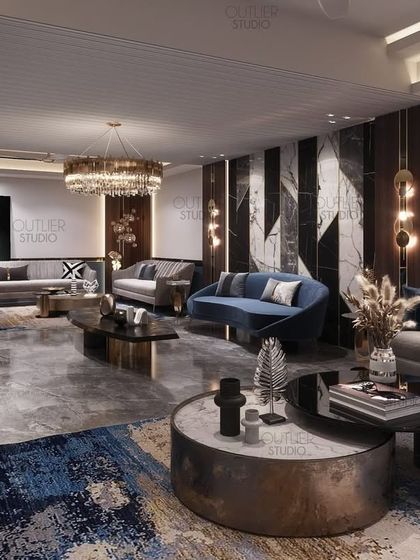 A spacious living room designed for entertaining, with multiple seating areas. The design uses a consistent color palette of blues and neutrals, with large abstract art pieces to tie the different zones together.