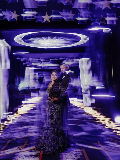 Another take on using motion blur to create a dynamic and artistic Sangeet portrait. The streaking lights give a sense of dizzying celebration, with the couple as the calm, happy center of it all.