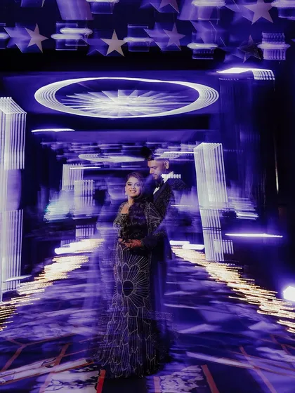 Another take on using motion blur to create a dynamic and artistic Sangeet portrait. The streaking lights give a sense of dizzying celebration, with the couple as the calm, happy center of it all.