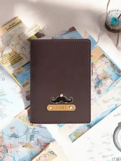 A personalized passport cover for 'Amit' with a mustache charm, displayed on a background of maps to evoke a sense of wanderlust and adventure.