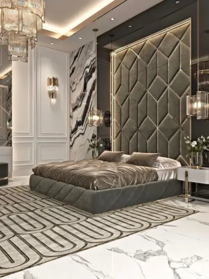 I design bedrooms that feel like a retreat from the world. This master bedroom features a floor-to-ceiling tufted headboard, marble-clad walls, and custom lighting to create an atmosphere of pure luxury.