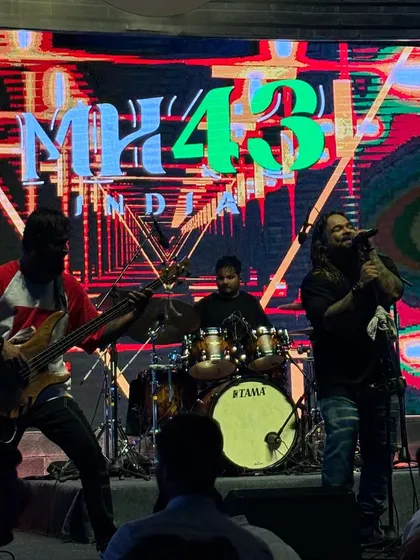 The full band rocking out on stage with our logo lit up behind us. A professional and high-impact look for any corporate event.