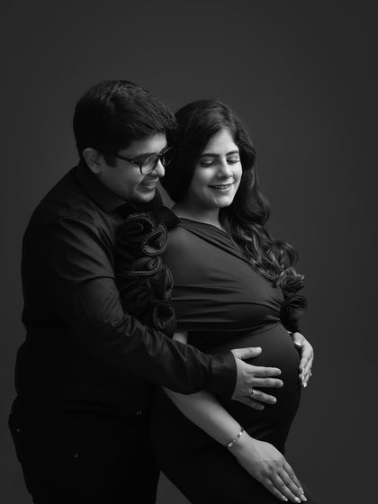 The gentle touch, the soft smiles. This black and white photo strips away everything but the pure, tender emotion between this couple as they cradle the baby bump.