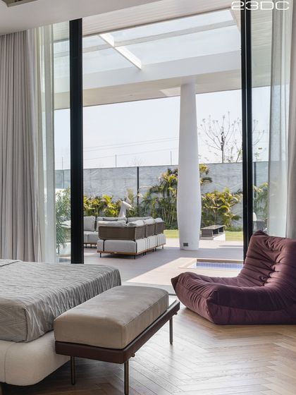 This bedroom opens directly onto a private terrace, blurring the line between indoors and outdoors. Waking up to soft sunlight and a view of the pool deck makes you want to stay in bed just a little longer.