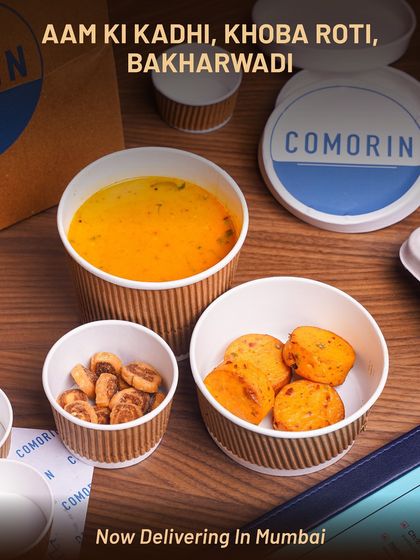 A comforting bowl of Aam ki Kadhi, delivered with crispy Khoba Roti and savory Bakharwadi. This meal balances tangy, sweet, and spicy flavors, making it a perfect light yet satisfying option.