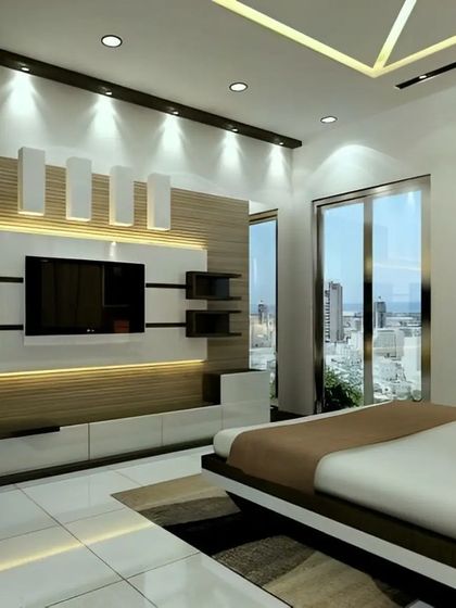 This bedroom features a sophisticated TV wall unit with a combination of white and wood panels and integrated lighting. It demonstrates how we can incorporate entertainment solutions seamlessly into a restful space.