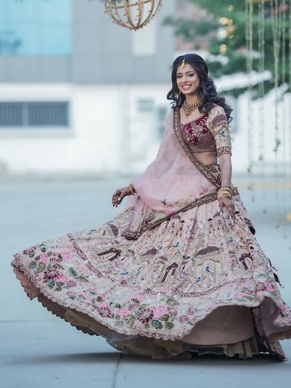A full-length shot capturing the beautiful movement of her reception lehenga. The entire look, from hair to makeup, is designed to be elegant and photogenic.
