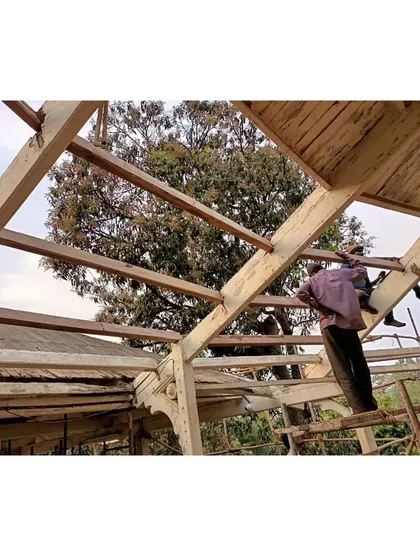 The complex process of restoring a 100-year-old Burma Teak roof structure. Our skilled team is seen here carefully assessing and reinforcing the original wooden beams, a critical step in ensuring the building's structural integrity for the next century.