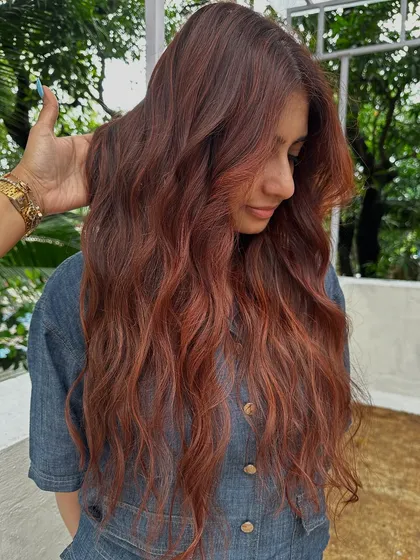 Holiday hair with a twist. This gorgeous reddish-copper color is perfect for making a statement on your next vacay. It’s warm, vibrant, and full of life.